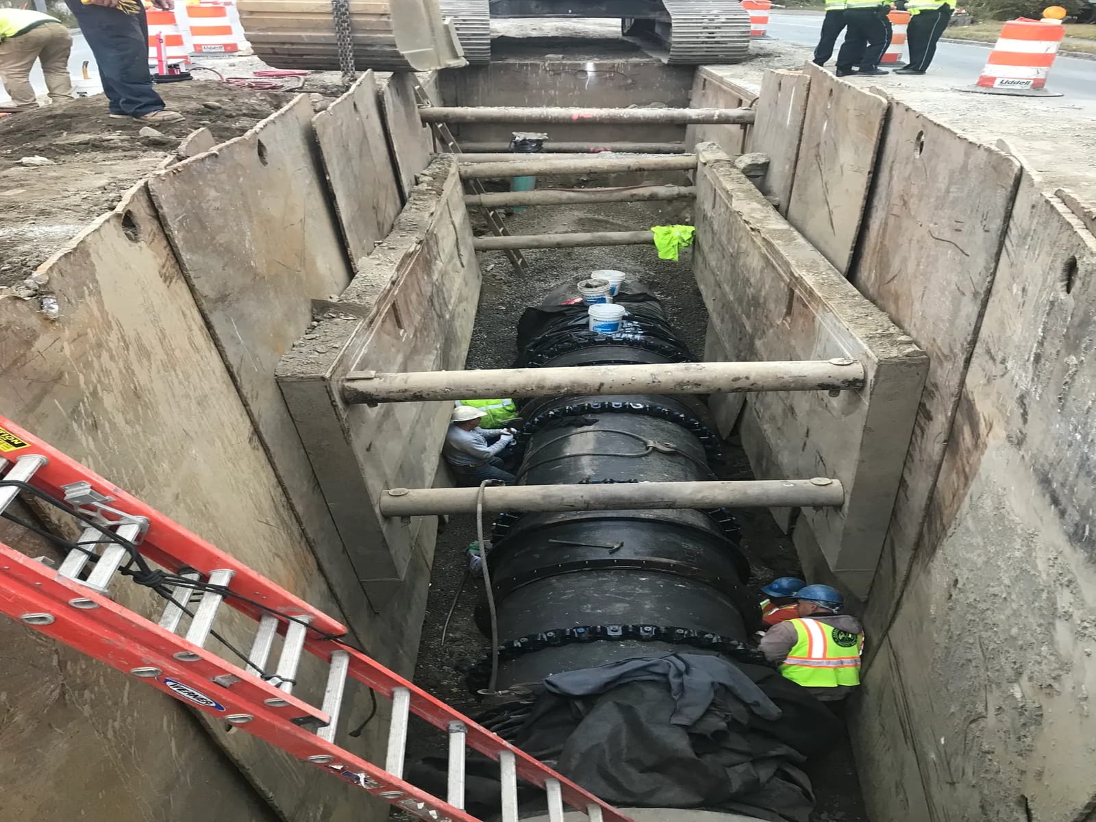 Pipe installation crew working inside a tunnel