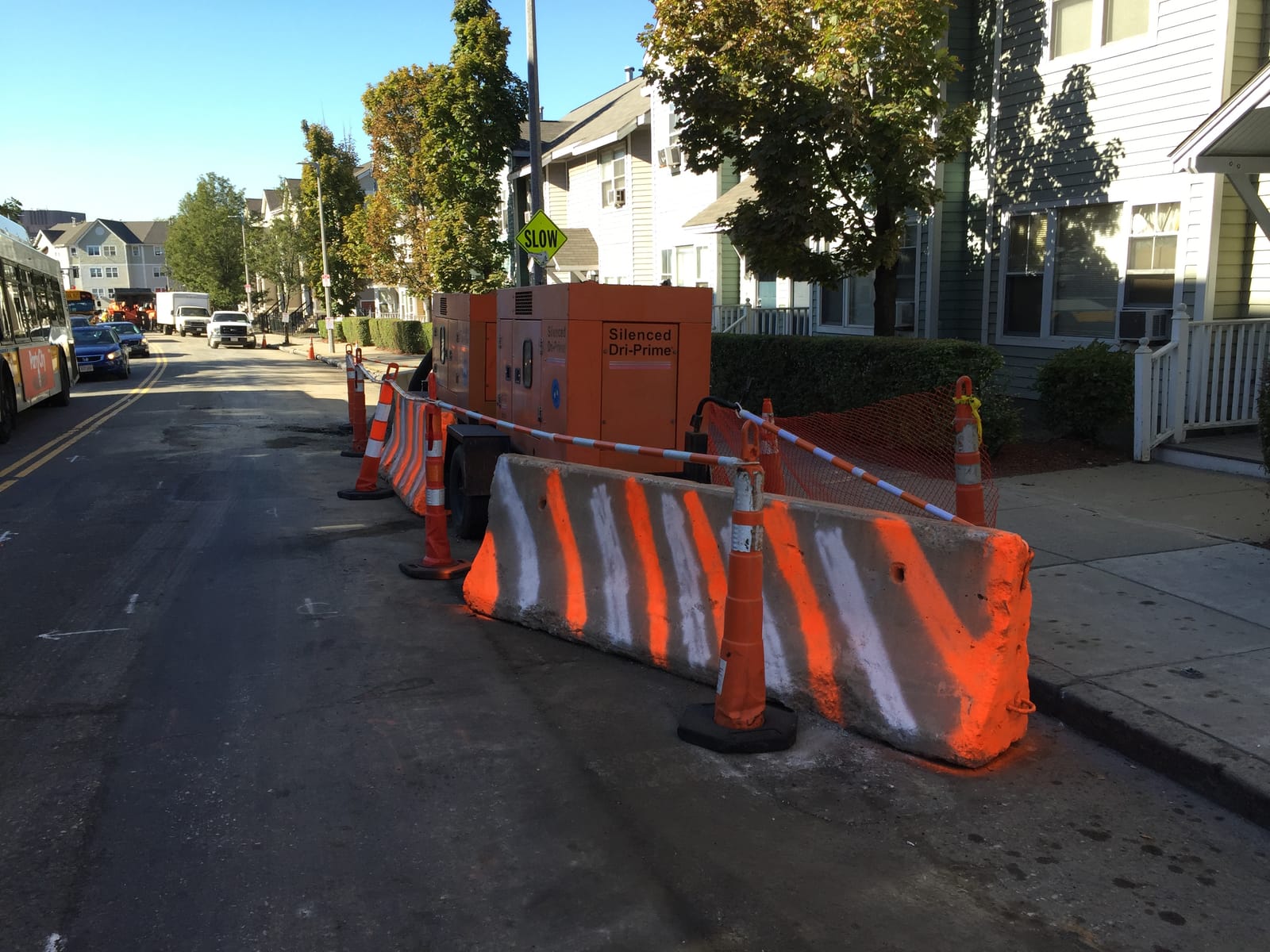 Work zone protected by traffic cones and barriers